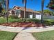 Charming single-story home featuring mature landscaping and a well-maintained lawn at 450 Morning Blossom Ln, Oviedo, FL 32765