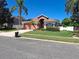 Well-maintained front yard with lush lawn, mature trees, and charming landscaping at 450 Morning Blossom Ln, Oviedo, FL 32765