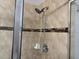 Glass-enclosed shower featuring a handheld showerhead and tiled walls with accent band at 457 Bridgeford Crossing Blvd, Davenport, FL 33837