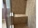 Shower featuring a built in bench and light brown tile at 457 Bridgeford Crossing Blvd, Davenport, FL 33837