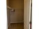 An organized walk-in closet with shelving and rods, and tan carpet at 457 Bridgeford Crossing Blvd, Davenport, FL 33837