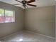 Bright bedroom featuring tile flooring and a ceiling fan at 4736 Southold St, Orlando, FL 32808