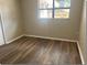 Bedroom with laminate flooring and a window that provides natural light at 4736 Southold St, Orlando, FL 32808