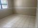 Cozy bedroom featuring tile flooring and a window with natural light at 4736 Southold St, Orlando, FL 32808