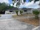 Charming single-story home featuring a well-maintained lawn and a long driveway at 4736 Southold St, Orlando, FL 32808