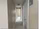 Hallway with tile flooring leading to various rooms and closet space at 4736 Southold St, Orlando, FL 32808