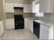 Kitchen featuring white cabinets, black appliances, and a stainless steel sink at 4736 Southold St, Orlando, FL 32808