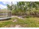 Spacious backyard featuring a screened-in patio and mature trees, great for outdoor enjoyment at 4800 Beacon St, Orlando, FL 32808