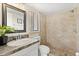 Updated bathroom featuring an updated vanity and a shower with stylish neutral tiling at 4800 Beacon St, Orlando, FL 32808