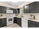 Stylish kitchen with dark cabinets, white countertops, and a stainless steel sink offering a modern cooking space at 4800 Beacon St, Orlando, FL 32808