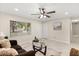 Bright living room with tile floors, ceiling fan, comfortable seating, and natural light creating inviting atmosphere at 4800 Beacon St, Orlando, FL 32808