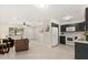 Open-concept living space with a kitchen view, a ceiling fan, and a welcoming atmosphere for relaxation and entertainment at 4800 Beacon St, Orlando, FL 32808