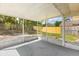 View of the screened-in patio looking out towards the fenced-in backyard with mature trees at 4800 Beacon St, Orlando, FL 32808