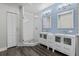 Modern bathroom with double vanity, walk-in shower, and stylish white-tiled walls and blue accents at 501 Mirasol Cir # 519, Celebration, FL 34747
