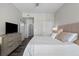 Comfortable bedroom featuring a bed, side table, and open door to the bathroom with sliding door at 501 Mirasol Cir # 519, Celebration, FL 34747