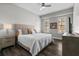 Cozy bedroom showcases a comfortable bed, and side table with lamp and a view through window at 501 Mirasol Cir # 519, Celebration, FL 34747