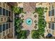 Aerial view of the property's courtyard and fountain surrounded by lush landscaping and the building at 501 Mirasol Cir # 519, Celebration, FL 34747