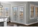 Elegant doors leading to a balcony, framed by windows and shutters, enhance the living space at 501 Mirasol Cir # 519, Celebration, FL 34747