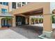 Covered entrance showing brick paving, large glass doors, and tropical planters at 501 Mirasol Cir # 519, Celebration, FL 34747