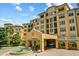 Stunning exterior view of a luxury condominium building with a beautiful fountain in the front at 501 Mirasol Cir # 519, Celebration, FL 34747