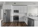 Modern kitchen featuring stainless steel appliances, white cabinetry, and dark hardwood floors at 501 Mirasol Cir # 519, Celebration, FL 34747
