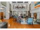 Spacious lobby with fireplace, piano, bookshelves, and ample seating with hardwood floors at 501 Mirasol Cir # 519, Celebration, FL 34747