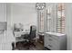 Bright office area features a white desk, chair, cabinetry and natural light through window shutters at 501 Mirasol Cir # 519, Celebration, FL 34747