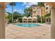 Beautiful pool area, cabana and mature landscaping surrounded by resort-style condominium building at 501 Mirasol Cir # 519, Celebration, FL 34747