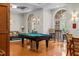 Bright pool room features a billiard table, hardwood floors, and ample natural light from surrounding windows at 501 Mirasol Cir # 519, Celebration, FL 34747