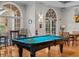 Bright pool room features a billiard table, hardwood floors, and ample natural light from surrounding windows at 501 Mirasol Cir # 519, Celebration, FL 34747