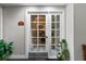 Spa entrance with glass door, gray walls, black flooring, and plants in decorative pots at 501 Mirasol Cir # 519, Celebration, FL 34747