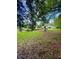 Enjoy the expansive backyard with a lush lawn, mature trees and wood deck at 532 Madison Ave, Orlando, FL 32805