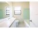 Bathroom featuring a single sink vanity, a tub, a tiled backsplash, and a window at 532 Madison Ave, Orlando, FL 32805