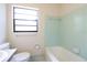 This bathroom features a classic tub with tile surround and a window for natural light at 532 Madison Ave, Orlando, FL 32805