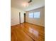 Bedroom with hardwood floors, closet, and a window providing ample natural light at 532 Madison Ave, Orlando, FL 32805