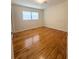 Bright bedroom featuring natural light, sleek hardwood floors, and ample closet space at 532 Madison Ave, Orlando, FL 32805