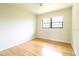 Bedroom features a neutral color scheme, hardwood flooring, and a window at 532 Madison Ave, Orlando, FL 32805