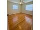 Bedroom with hardwood floors, ceiling fan, and two windows at 532 Madison Ave, Orlando, FL 32805