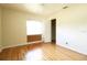 A light-filled bedroom with hardwood flooring, a neutral color scheme, and a window at 532 Madison Ave, Orlando, FL 32805