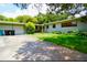 Single-story home features a garage, driveway, front yard, and lush landscaping at 532 Madison Ave, Orlando, FL 32805
