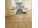 Galley kitchen featuring white cabinets, an island, and an easy flow into the living area at 532 Madison Ave, Orlando, FL 32805