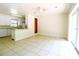 Open-concept kitchen and dining area with tile flooring, white cabinetry, a breakfast bar, and outdoor access at 532 Madison Ave, Orlando, FL 32805