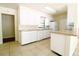 A bright kitchen features white cabinets, countertops and tile flooring at 532 Madison Ave, Orlando, FL 32805