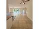 Open concept living and dining area with tiled floors, ceiling fans, and sliding glass doors to the backyard at 532 Madison Ave, Orlando, FL 32805