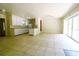 Open-concept living area with tile flooring, sliding glass doors and view into the kitchen at 532 Madison Ave, Orlando, FL 32805