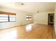 Large living room with hardwood flooring, ceiling fans, and window coverings adding to the living space's comfort at 532 Madison Ave, Orlando, FL 32805