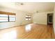 Large living room with hardwood flooring, ceiling fans, and window coverings adding to the living space's comfort at 532 Madison Ave, Orlando, FL 32805