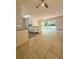 Spacious living and dining area features tile flooring, a ceiling fan, and sliding glass doors leading to the yard at 532 Madison Ave, Orlando, FL 32805