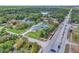 Wide aerial perspective highlighting a large home and its location near a main road at 5800 Spruce Creek Woods Dr, Port Orange, FL 32127
