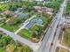 An aerial shot showcases a substantial property with a long driveway, a private pool, and proximity to the main road at 5800 Spruce Creek Woods Dr, Port Orange, FL 32127